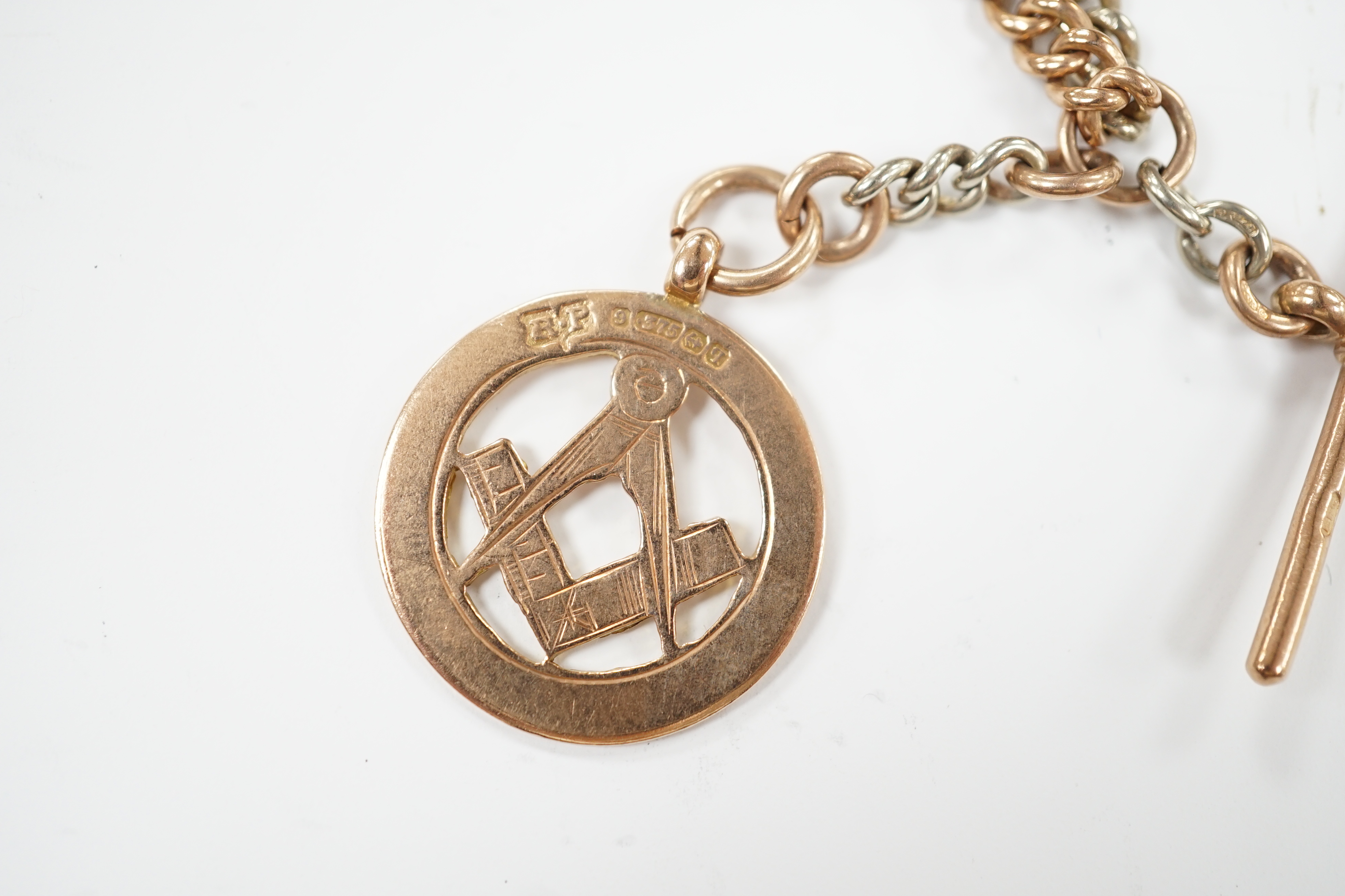 A two colour 9ct gold albert, 40cm, hung with a 9ct gold masonic medal, together with a 9ct masonic ring, gross weight 36.9 grams.